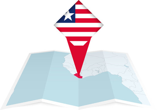 Liberia pin flag and map on a folded map
