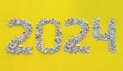 2024 Written with Popcorn on Yellow Background, Happy New Year 2024 Wishing Conceptual Photo
