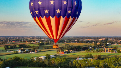An Aerial View of One Hot Air Balloon Floating Away in Rural Pennsylvania at Sunrise on a Sunny...