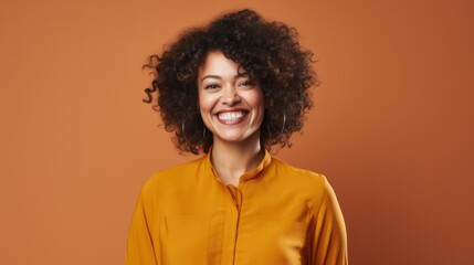 Obraz na płótnie Canvas African American smiling charming positive woman, happy joyful cheerful lady laughing having fun, looking at camera, standing isolated at orange background, close up headshot portrait.