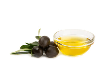 Bowl of fresh olive oil and olives with leaves isolated on white background. Delicious olive oil in a glass bowl. olive oil bottle.