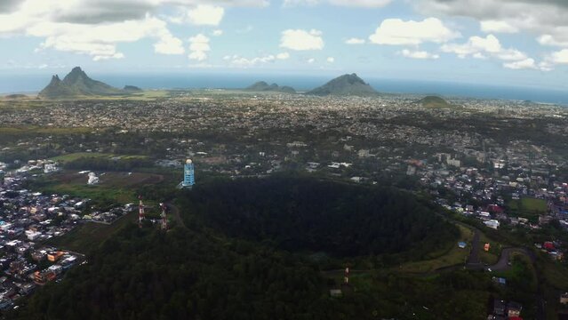 Flying drone 4K video over Trou aux Cerfs dormant volcano crater covered exotic trees and plants. Mauritius island losted in Indian ocean.