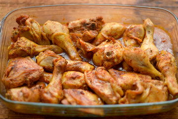Marinated chicken drumsticks, rich in spices, ready to cook.