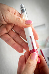 Close upshot of the woman preparing medicine for injection. Healthcare