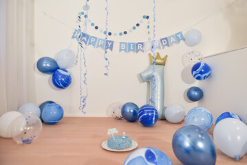 first birthday party decoration with blue balloons for a one year old boy, empty copyspace...