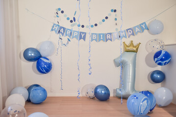 first birthday party decoration with blue balloons for a one year old boy, empty copyspace...