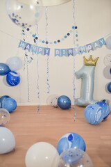 first birthday party decoration with blue balloons for a one year old boy, empty copyspace...