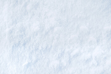 Background of fresh snow texture in blue tone. Snowy white texture. Snowflakes.