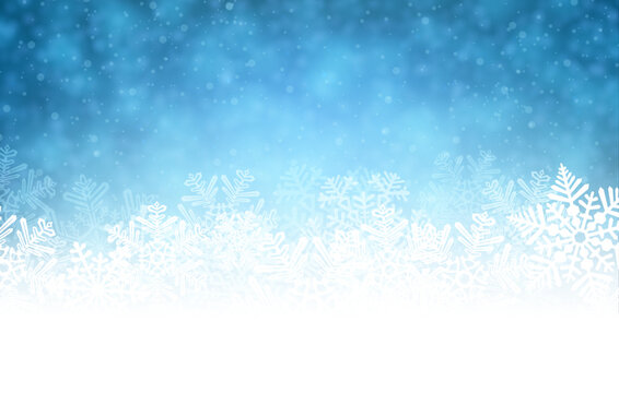 White rough snow background on blue textured pattern with blurred snowflakes.
