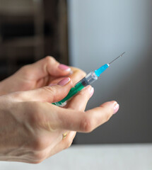 Close upshot of the woman preparing medicine for injection. Healthcare