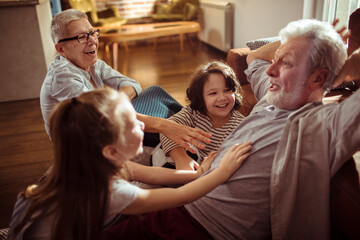 Grandparents having fun with Grandkids in the living room