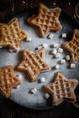 Belgian waffles with pine tree on background with Christmas light 