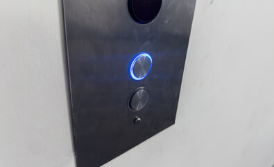 hand pressing elevator button, symbolizing choice and progress