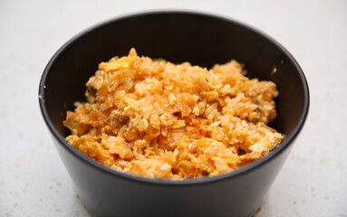 fried rice dish with vibrant vegetables and spices on a ceramic plate