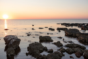Rocks on sea in sunset