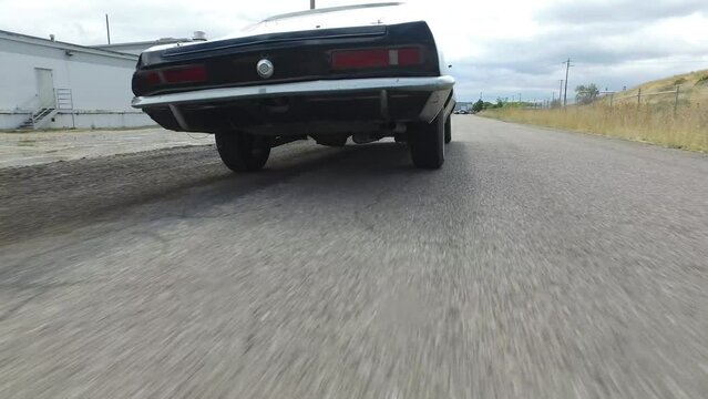 Cinematic shot following stunt vehicle down road
