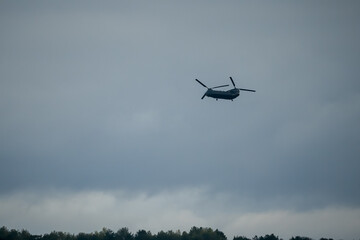 An RAF Chinook tandem-rotor CH-47 helicopter flying low on a military battle exercise, Wilts UK