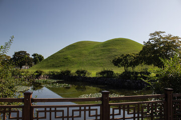 Daereungwon Tomb Complex in Gyeongju, South Korea, showcasing lush greenery, royal mounds, a...