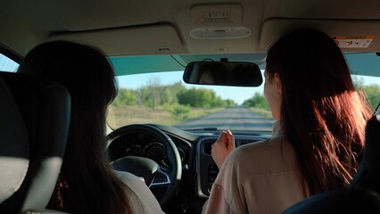 dancing girls driving car. travel machine. enjoying music, having cheerful time together, beautiful...