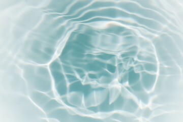 Bluewater waves on the surface ripples blurred. Defocus blurred transparent blue colored clear calm water surface texture with splash and bubbles. Water waves with shining pattern texture background.