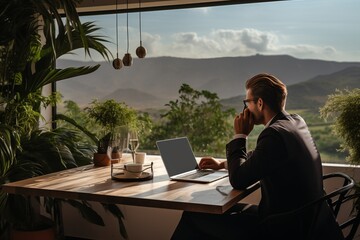 Remote work with a view  man working outdoors in a country backyard house with mountain scenery