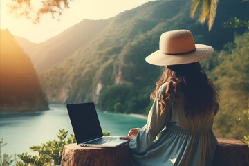 Young woman freelancer working online with laptop and enjoying stunning mountain landscape - obrazy, fototapety, plakaty