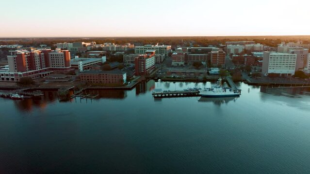 Sunrise over downtown Wilmington, North Carolina, showcasing the cityscape's warm hues against the waking sky.