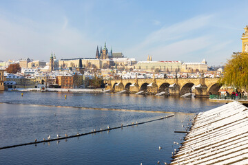Snowy Prague Lesser Town with Prague Castle and Charles Bridge above River Vltava in the sunny Day , Czech republic