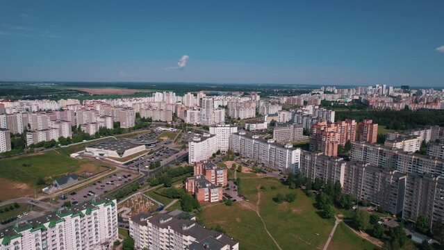 Aerial view of residential microdistrict on outskirts of city with parking for cars and modern infrastructure