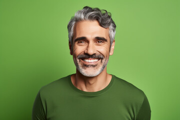 Fototapeta premium medium shot portrait photography of a pleased man in his 50s against a light green background