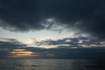 Cloudy sunset on the seashore, beautiful sunset by the sea