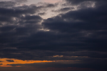 Beautiful orange sunset with big rain clouds