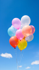 Some colorful balloons in a blue sky