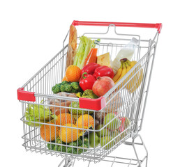 Shopping cart with fresh groceries on white background