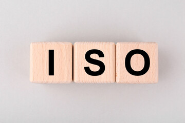 International Organization for Standardization. Cubes with abbreviation ISO on light grey...