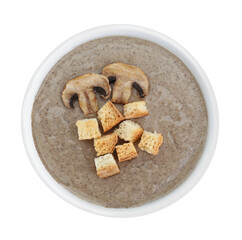 Delicious mushroom cream soup with croutons in bowl isolated on white, top view