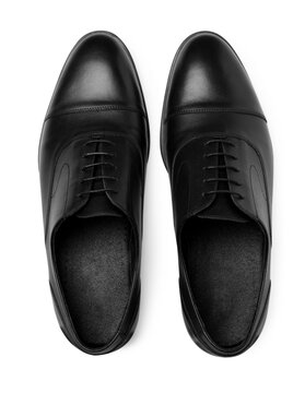 Pair of black leather men shoes on white background, top view