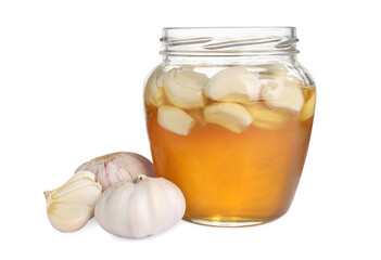 Honey with garlic in glass jar isolated on white