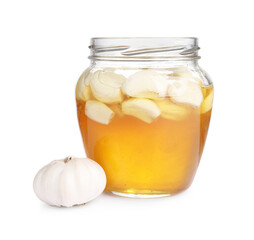 Honey with garlic in glass jar isolated on white