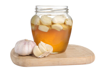Honey with garlic in glass jar isolated on white