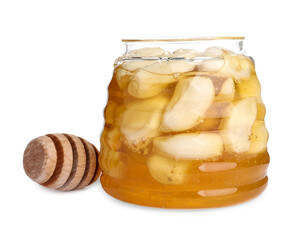 Honey with garlic in glass jar and dipper isolated on white