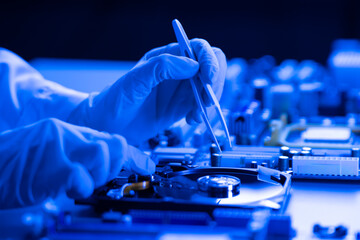 person in gloves work in laboratory, repair broken hdd hard drive