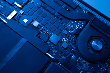 a disassembled laptop, close up shot, black circuit board of computer