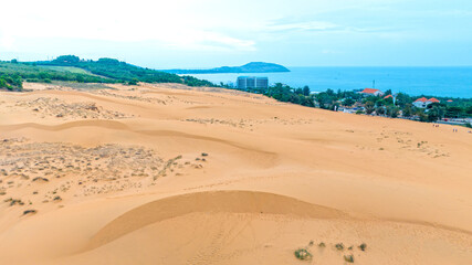 Stark geographical contrast between sand and water near Mui Ne, Vietnam. Mui Ne Desert of Vietnam is a desert in Southeast Asia