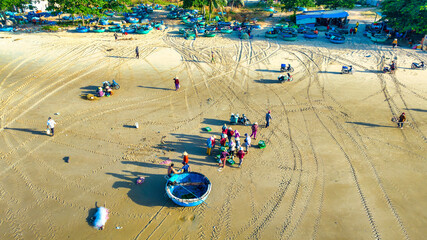 Mui Ne fish market seen from above, the morning market in a coastal fishing village to buy and sell...