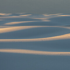Waves of Light and White Sand Dunes Layers Across Hillside
