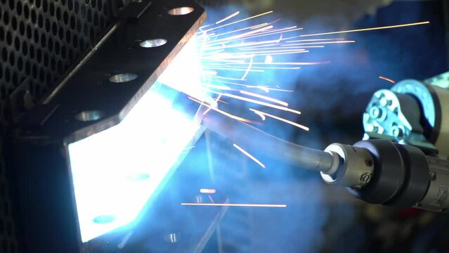 Industrial robot is welding automotive part in Asia.