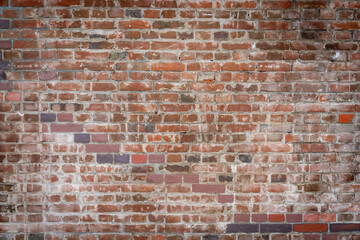 Old brick color stone wall There are natural stains. Close up.