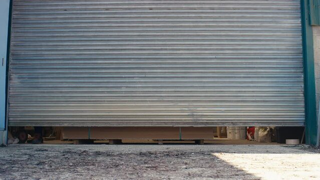 Male Carpenter With Pet Dog Opening Door To Woodwork Or Joinery Business Premises At The Start Of The Working Day - Shot In Slow Motion