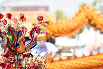 Colorful Chinese dragon toys in Chinese New Year festival.Chinese New Year Decoration, Dragon toy paper on festive background.